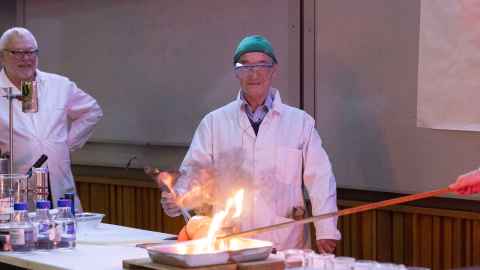 David Williams immersing blow torch in a dish of soap to make bubbles that become full of explosive gas mixture. Ignite (from a distance) by touching a glowing candle to the bubbles.