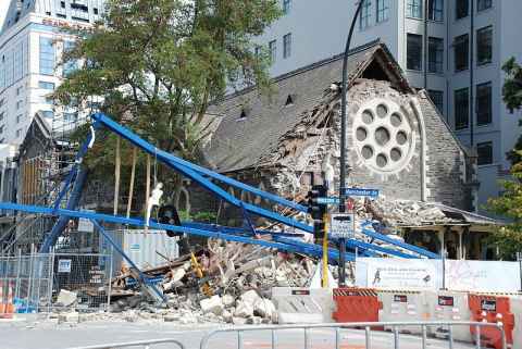 The Christchurch Cathedral after the 2011 earthquake, damaged and surrounded by rubble.