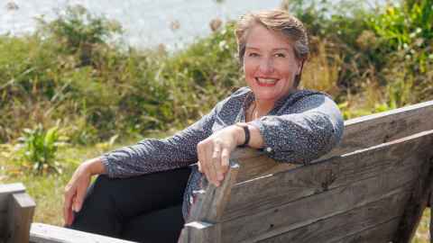 Associate Professor Linda Tyler on a park bench outdoors.