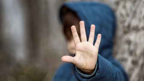 image of child holding hand in stop gesture