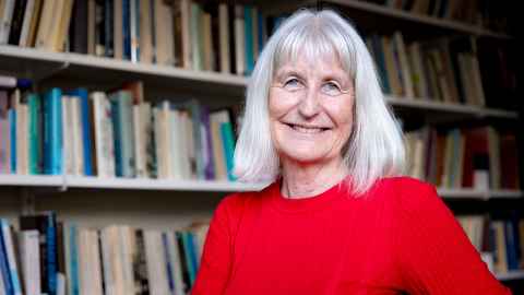Professor Linda Bryder is a medical historian. She's standing in front of her bookshelves