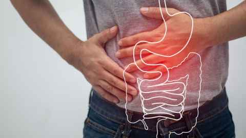 generic photo of man with stomach pain overlaid with drawing of gastrointestinal tract