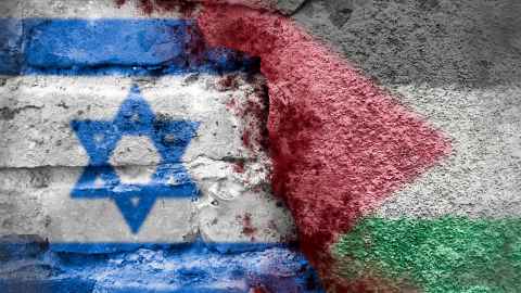Israel and Palestine flags painted on a cracked brick wall