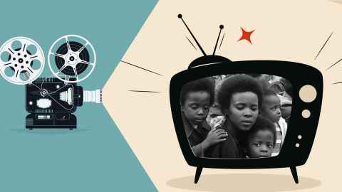 Cartoon reel to reel camera pointing at a TV showing an old movie