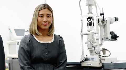 Catherine Jennings beside an eye-testing machine.