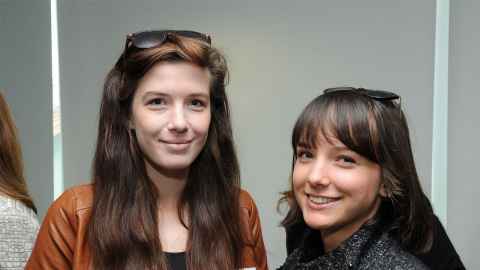 Two young women, smiling