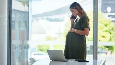 Pregnant working woman istock