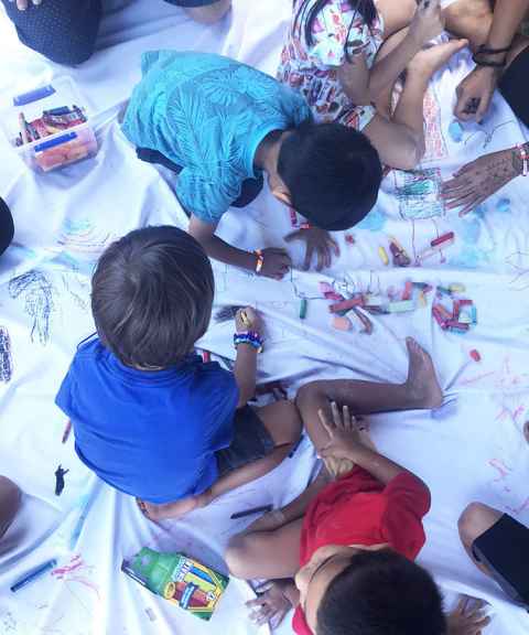 Children in Lahaina drawing dreams and memories on the 'dream blanket' as part of  the ' Teaspoon of Light' activity which has been used in other post-disaster contexts.