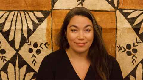 Sarah Kapeli in front of a tapa cloth.