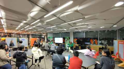 A room full of students with a dog and several people at the front