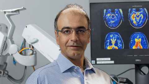 Dr Abbasi in a hospital setting with brain screens