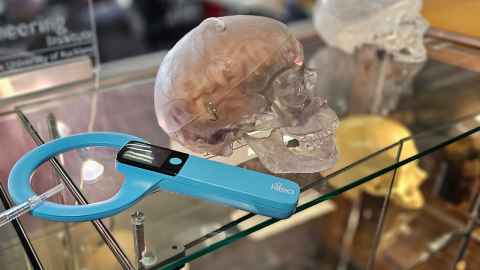 pic of clear skull and blue round sensor wand