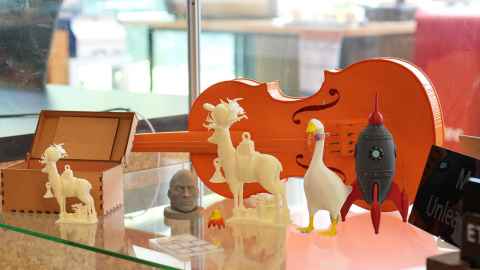 3D printed items, including a violin and animal figures.