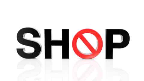 A SHOP sign with a cross through the zero