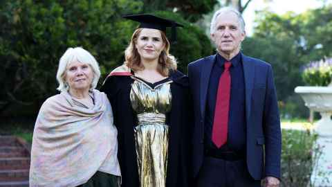 Sophie Scott-Elvidge with her parents in the gardens of Old Government House.