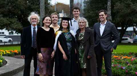 Design and Global Studies graduate Leah Kampkes with her whānau on graduation day.