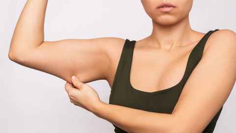 woman tugging on swollen arm