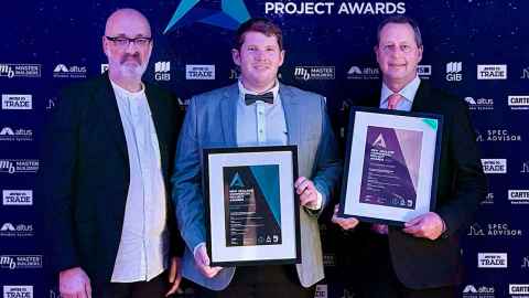Three award winners holding their certificates
