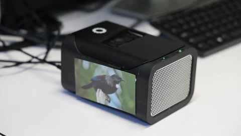 The black box sequencing machine with a picture of a tui on the side