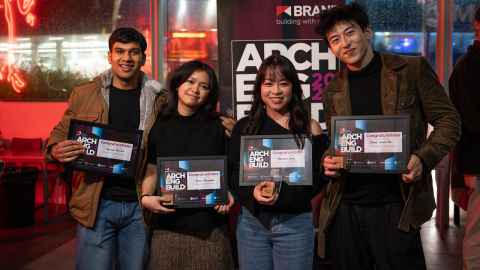 Four students pose for a photo with certificates.
