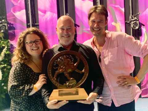 Morag, David and Michael hold the choir of the world trophy.
