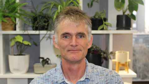 David in front of shelving with plants