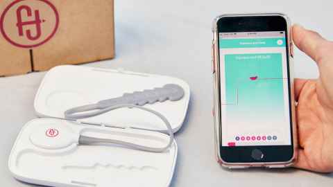 Device in white box with mobile phone