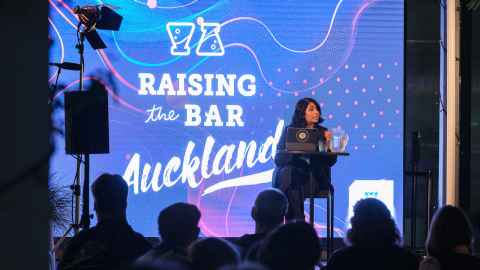 University academic speaking to a crowd at Raising The Bar