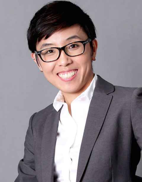 Head and shoulders of Danping Wang, wearing a white shirt, grey suit jacked and black glasses.