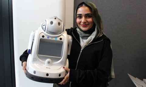 Zahra Ally with the robot, iRobi, which she will test with older people.
