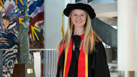 Alex Pennycuick on graduation day in her doctoral robes inside the Aotea Centre