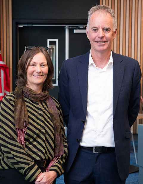 Rebecca Jesson and Aaron Wilson at her inaugural lecture with a door in the background.