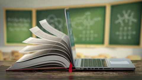 book flapping on teacher's desk, in classroom