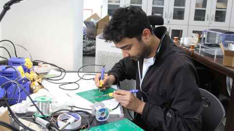 Saidul Alam Chowdhury in the lab, working on the SmartPowerBox prototype.