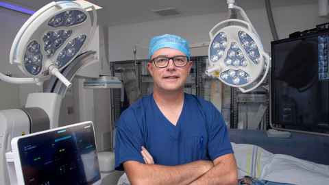 Martin in scrubs standing an operating theatre