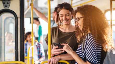 Two students talking while on the bus