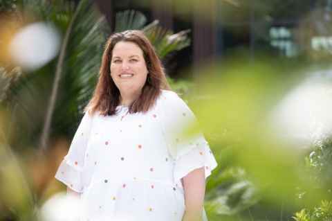 Rosalind Arnott is pictured smiling in outdoor area.