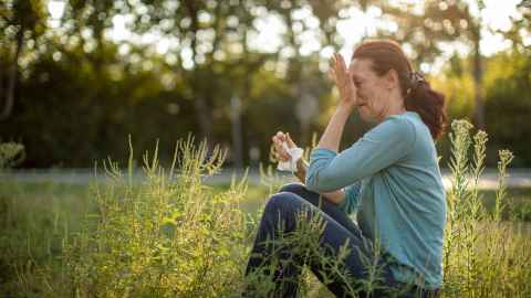 woman in field with hay fever