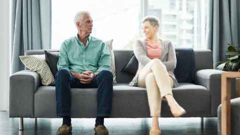 Image of man, sitting on couch with 'ghost' image of wife. 