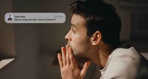 Young man with text message on screen from Toku Hoa