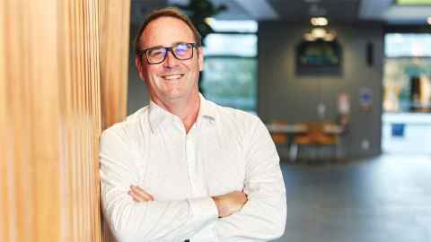 Justin leaning against a wall at the Liggins Institute