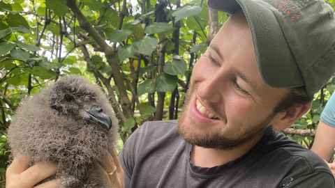 Michael Fox holding a very fluffy petrel. 