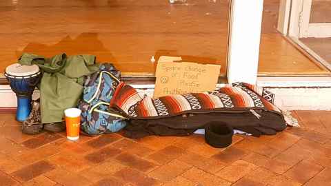 Homeless person's set up of blanket, water bottle etc. 