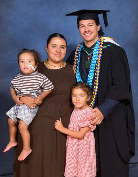Tane Marsters on graduation day, 10 March, with his partner Aorangi and his son Kokowai and daughter Kahikatea. Photo: Peter Davies Photography 