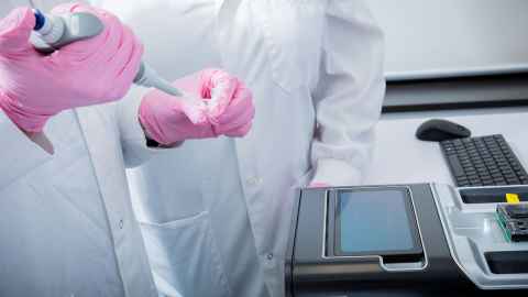 Pipetting a DNA sample into the University's state-of-art genetic testing device.