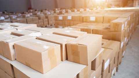 Warehouse filed with plain brown packing boxes without any branding
