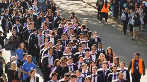 Students walking in graduation procession.