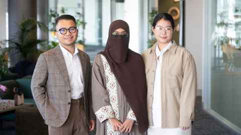 (From left to right) Oh Sri-ubon, Syeda Mahnaaz Jabeen and Xiaoran Chen in business attire standing in a room.