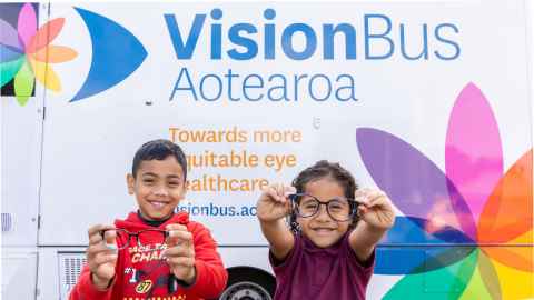 Two schoolchildren visit Vision Bus Aotearoa.