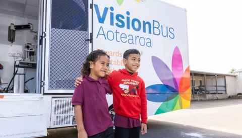 Schoolchildren outside Vision Bus Aotearoa.